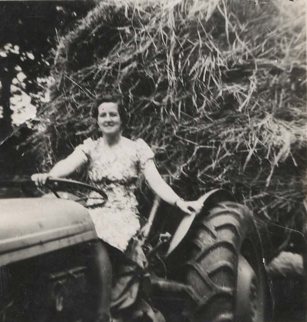 Doris Bosomworth with a Ferguson tractor at Westmoor Farm, Finghall